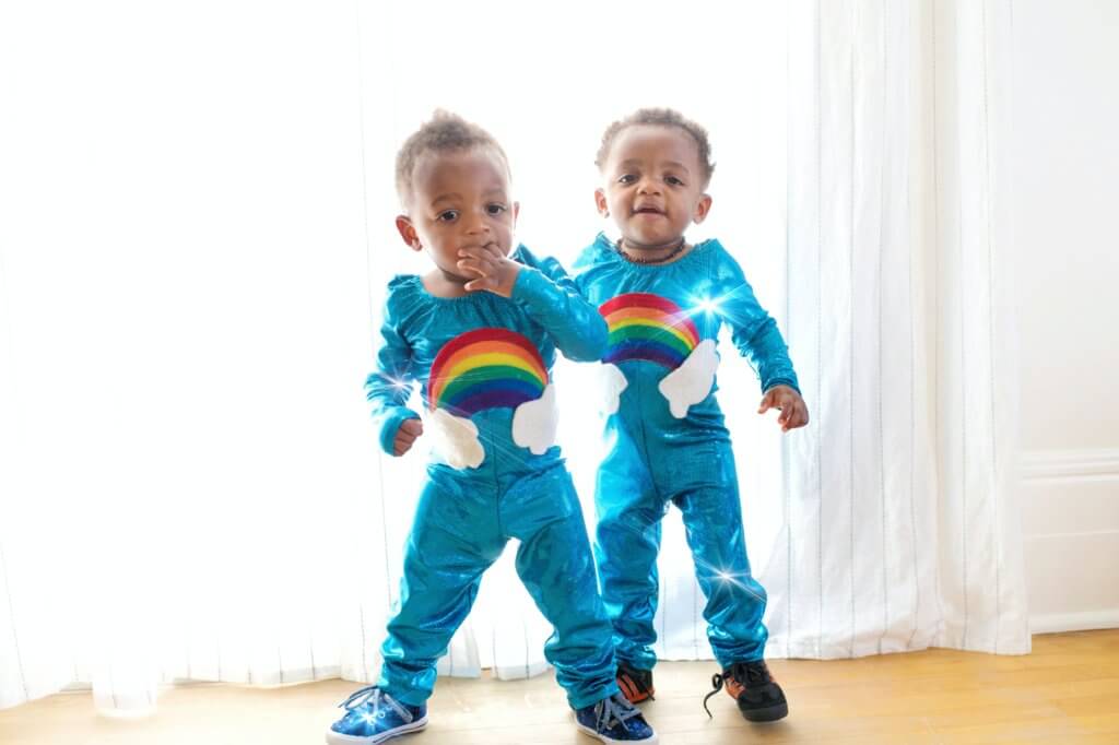 Twin toddles in rainbow super suits