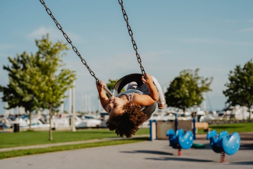 small child on swing during a summer day