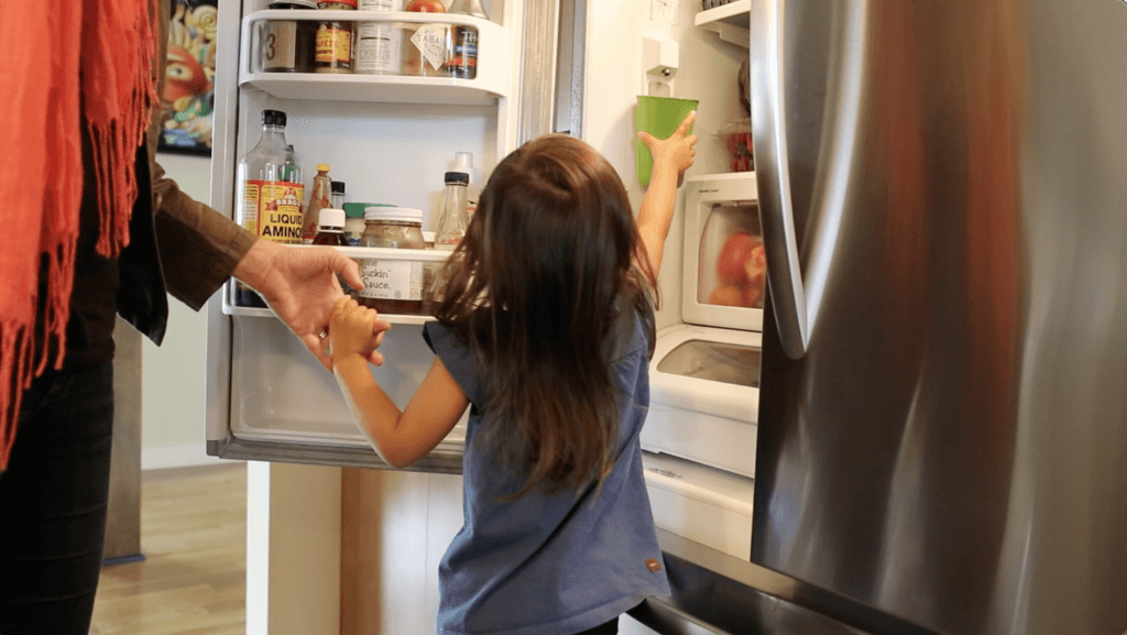 Child about three years old filling their own water cup